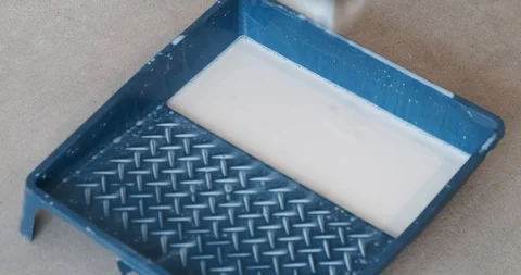 Close-up of plastic construction tray, construction roller dipped in solution Stock Footage 129837482