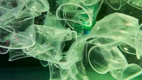 Close-up of plastic debris floating under surface in blue water, Slow motion Stock-Footage 255975321