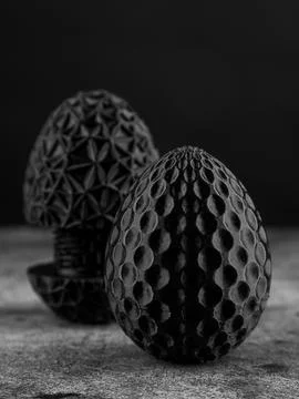 Close-up of a plastic egg model with ornament on a black background Foto stock