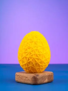 Close-up of a plastic egg model with ornament on a  purple   background Stock Photos