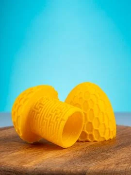 Close-up of a plastic egg model with ornament on a blue background Stock Photos