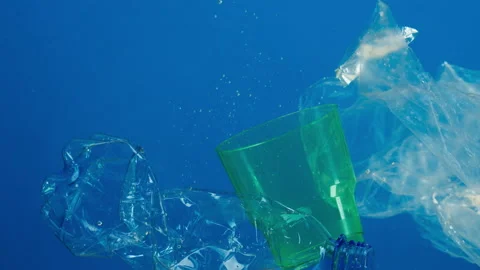 Close-up of plastic glasses and bottles in ocean, water pollution concept Stock Footage 156507349