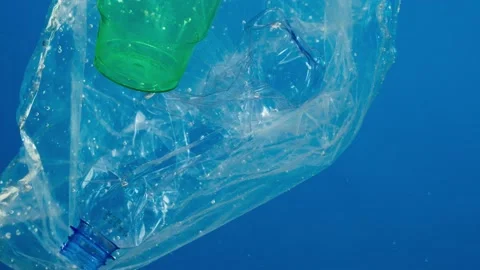 Close-up of plastic glasses and bottles in ocean, water pollution concept Stock Footage 156821670
