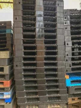Close up plastic pallets stacked in a warehouse Stock Photos