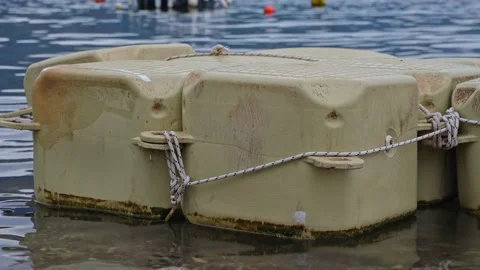 Close-up of plastic pontoons floating in the sea. Pontoons for quick assembly of Stock Footage 218953315