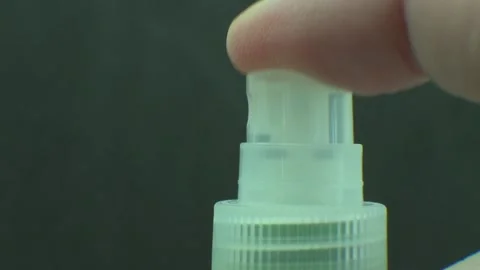 Close up of a plastic spray bottle  pouring liquid. Slow motion footage. Stock Footage 158925095