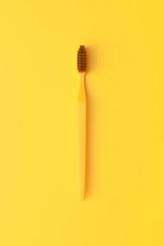 Close-up plastic toothbrush on the yellow background Stock Illustration