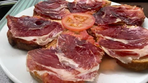 Close up of a plate of bread with Serrano ham and olive oil (tapa) decorated  動画素材 155959892