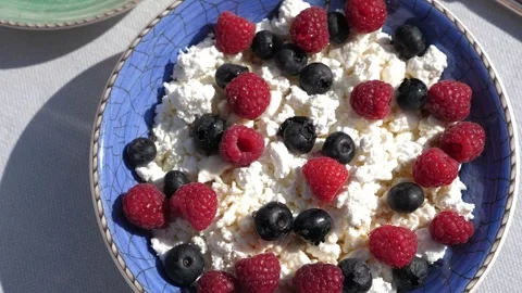 A close-up of a plate with cottage cheese and fresh berries. Stock Footage 291515840