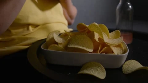 Close up of a plate filled with potato chips held by a woman. 库存影片 336917409