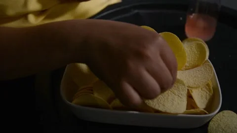 Close up of a plate filled with potato chips held by a woman. 스톡 동영상 336917419