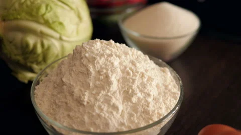 Close-up of a plate of flour in the kitchen, next to eggs and vegetables. Stock Footage 120840188