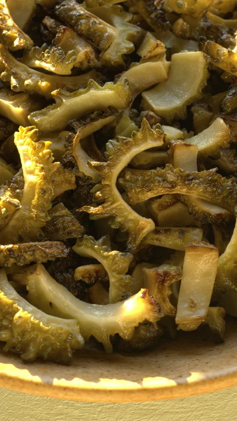 Close-up of a plate with fried bitter melon slices. Stock-Footage 346188793