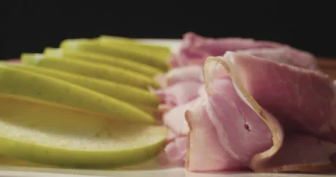 Close-up of a plate of ham, apple slices, and cheese. Stock Footage 130761068