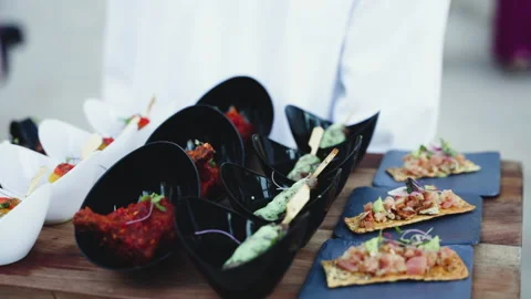 Close-up of a plate with snacks in the hands of a waiter Stock Footage 239463090