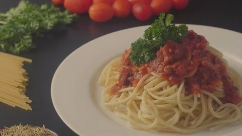 Close up on a plate of spaghetti served with minced beef and sausage sauce and i Stock Footage 108178222