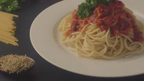 Close up on a plate of spaghetti served with minced beef and sausage sauce and i Stock Footage 108178230