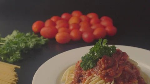 Close up on a plate of spaghetti served with minced beef and sausage sauce and i Stock Footage 108178251