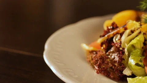 Close-up of a plate on which sliced thin-sliced light-salted salmon with green Stock Footage 116688316