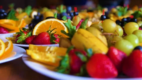 Close-up of plates with different types of fruit and berries on a buffet table. Stock Footage 274259852