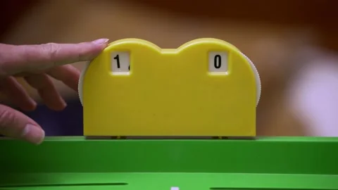 Close-up of a player's hand updating the score on a plastic scoreboard. 스톡 동영상 200821453