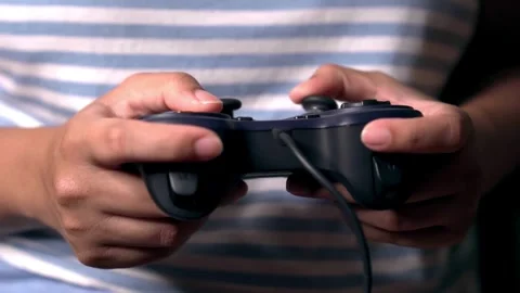 Close-up of players' hands holding a joystick. With a wireless console game Stock Footage 334653308