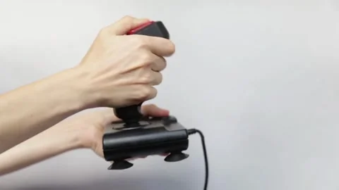 Close-up of players' hands holding a joystick. With a wireless console game 库存影片 334653323