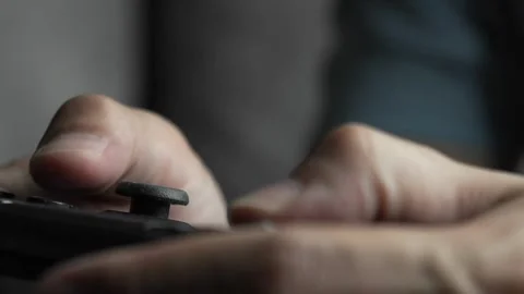 Close-up of players' hands holding a joystick. With a wireless console game 스톡 동영상 334653356