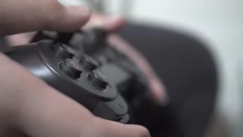 Close-up of players' hands holding a joystick. With a wireless console game Vídeos de archivo 334653789