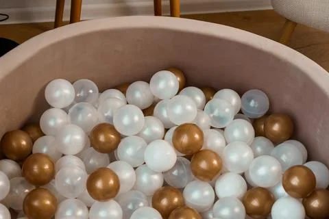 Close-up of a Playful Soft Pool Filled with Shiny Brown, White, and Transpa.. Stock Photos