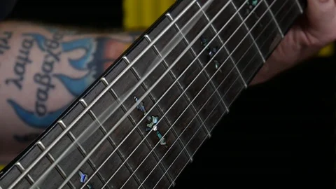 Close Up Playing 9 String Guitar 8th String Vibrating Video stock 96823700