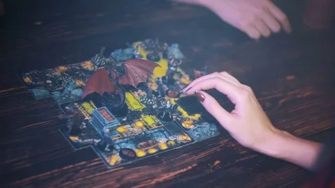 Close up of playing in fantasy board game Descent, woman hand moving figures Stock Footage 79450892