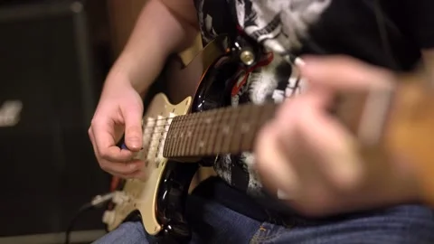 Close-up, playing the guitar, frame of hands playing the strings Vidéo 149616048