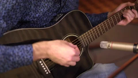 Close-up, playing the guitar, frame of hands playing the strings Vidéo 149616843