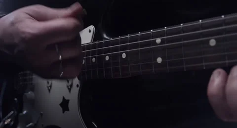 Close-up of playing the guitar with a pick Stock Footage 153918359