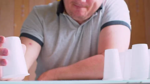 Close-up of playing with plastic cups on a table. Stock Footage 336204977