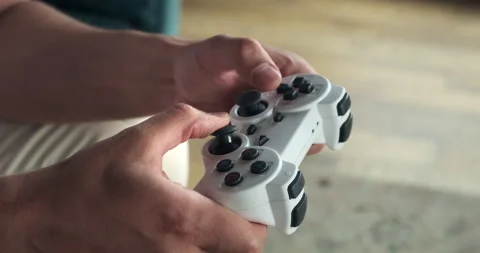 Close up of playing video games while holding a game controller. Stock-Footage 156870671