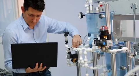 Close up of PLC programming Engineer's laptop and analog process automation k Stock Photos