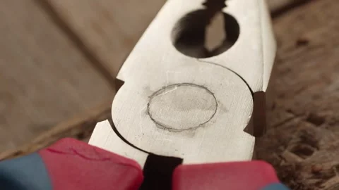 Close-up of Pliers Clamping Rusty Nail. Stock Footage 258936505