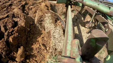 Close up of plow chisel turn the soil while Farmer prepares field for 스톡 동영상 275166239