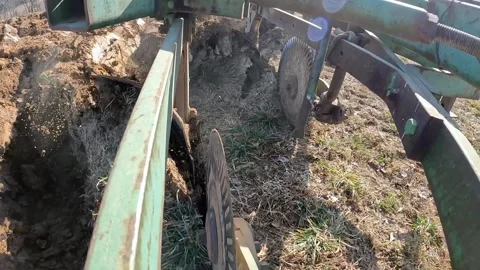 Close up  of plow as the soil is cut and turned; Farmer lowers disc and Video stock 275218378