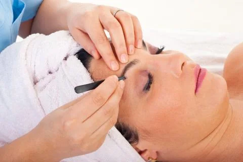 Close up of plucking eyebrows Stock Photos