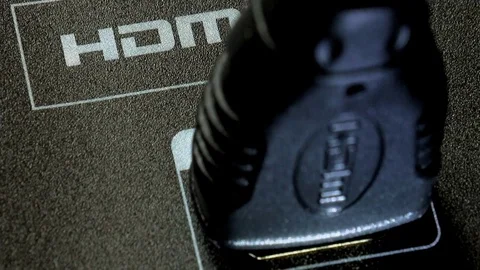 Close up of a plugging in a HDMI cord into the socket on the TV. Stock Footage