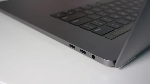 Close up, plugging in a USB-C / Type C cable to a modern notebook computer Stock Footage 95126633