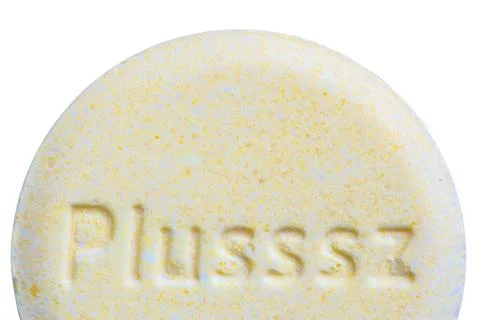Close up on Plusssz multivitamin round effervescent tablet on white backgroun Stock Photos