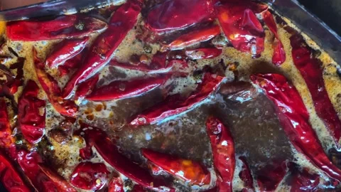 Close-up of the pod red chili pepper pods boiling in broth Stock Footage 280377760