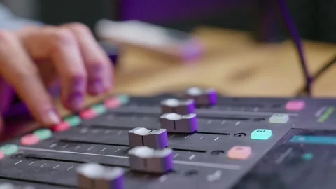 Close up on podcast sound console or audio recording mixer - man's hand Stock Footage 304428019