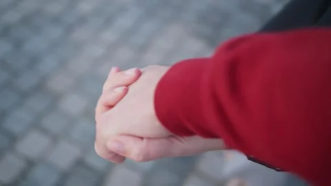 Close up point of view couple holding hands walking outside in street in winter Stock Footage 304462154