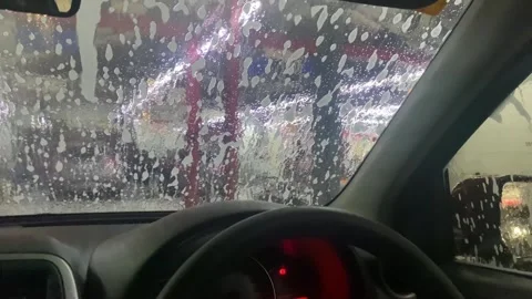 Close-up point of view from inside the car, at an automatic car wash. The c.. Stock Footage 293646413