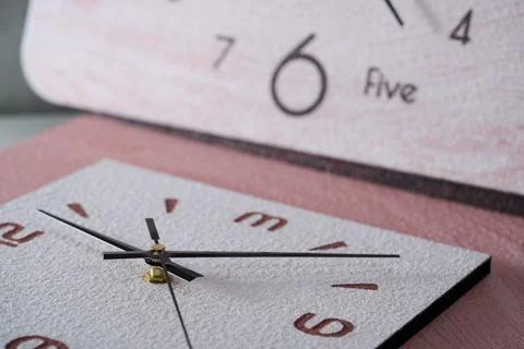 Close-up of pointer clock on wood grain stone texture surface Stock Photos